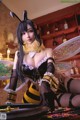 A woman dressed as a bee sitting at a table.