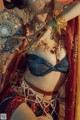 A woman in a belly dance costume holding a plate.