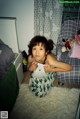 A little girl sitting on the floor in a room.